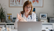 A doctor on a virtual consultation using a laptop computer 