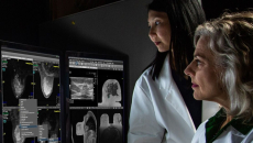 Two doctors in front of computer screens 