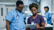 Healthcare workers in hospital looking at a tablet