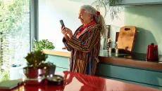 Woman takes a telehealth call at home