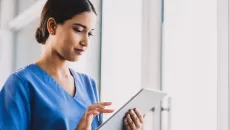 Clinician looks at data on a tablet