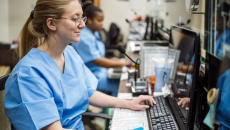 Two nurses working the reception in a clinic
