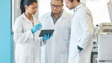 Doctors review information on a tablet