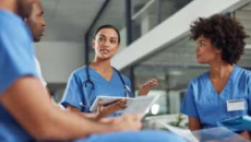 Group of healthcare workers in scrubs meeting