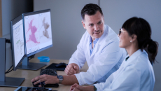 Two pathologists analysing digital slides