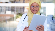 A doctor using a digital tablet