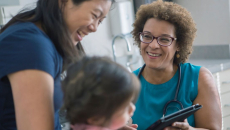 A parent with a child in a consultation with a doctor