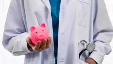 Doctor holding piggy bank