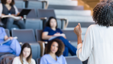 An instructor teaching a class of medical students
