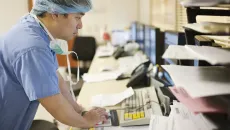 Surgeon reviews information on a desktop 