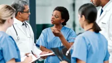 Clinicians huddle to discuss care plan