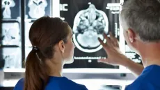 Doctors look at brain imaging on a monitor