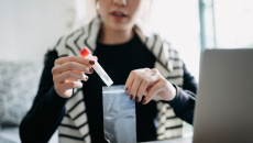  A patient inserting a test tube into a pouch 