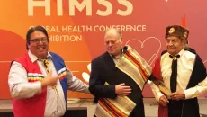 Robert Coffey, left, and Wallace Coffey, far right, honor HIMSS President and CEO Hal Wolf at the HIMSS Native American & Indigenous Health Symposium on Monday.