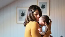 Mother holds baby