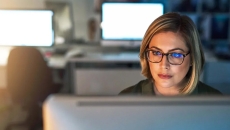 Revenue cycle management employee at a computer terminal  