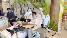 An assistive robot helping a patient with limited hand mobility to feed themselves