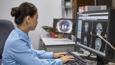 A radiologist examining X-ray images on a desktop computer