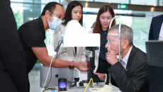 Singaporean Foreign Affairs Minister Dr Vivian Balakrishnan tries out the Automated Visual Acuity Test at the launch event of NUS Medicine's Centre for Innovation and Precision Eye Health.