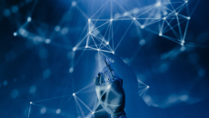 A robotic hand reaches into lights that represent data points.