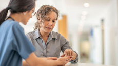 Doctor and patient work with smartphone