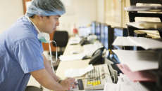 Doctor in scrubs using computer