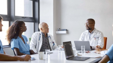 Doctors and other medical workers meeting in a conference room.
