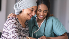 Cancer patient embracing healthcare worker