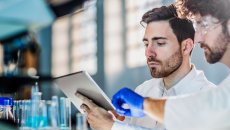 Laboratory workers using tablet
