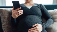 Pregnant person with phone