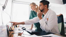 Healthcare worker pointing at a screen