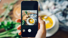 Person taking photo of food with a smartphone