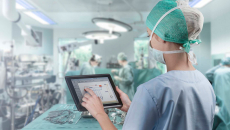 Healthcare worker in surgery room with tablet
