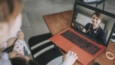 Person attending telehealth appointment on laptop