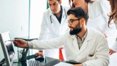 clinicians looking at a laptop screen