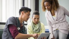 Healthcare worker showing tablet to patients