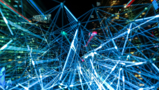 Data exchange represented by blue lights with a city in the background