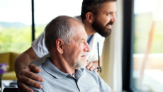Two people looking out a window