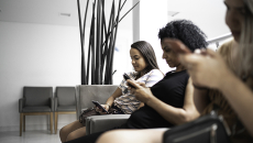 People with smartphones in a waiting room