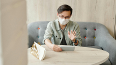 A patient wearing mask at home in an online consultation.