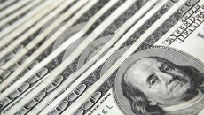 $100 bills laid out in fan succession