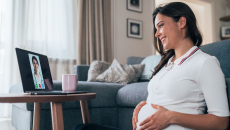 Pregnant person talking to doctor on tablet