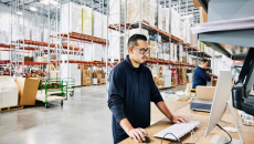Workers in a warehouse on computers