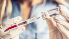 Healthcare worker filling syringe