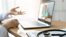 A female surgeon appears on a laptop with a stethoscope in foreground.