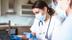 clinical researchers looking at data on a screen