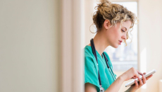 A doctor checking electronic records on a digital tablet