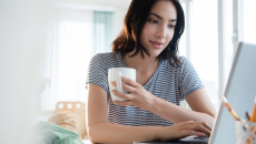 Woman on laptop engages in telehealth coaching