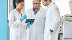 Doctors looking at a tablet