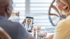 Two people on a telehealth call with medication on the table